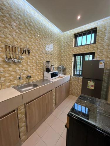 a kitchen with a sink and a counter top at EZK Appart in Kika