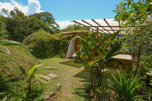a path through a garden with a tent at Vibra Wellness Hotel y Spa in Teniente Hugo Ortiz