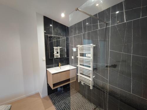 a bathroom with a sink and a mirror at A Cozy Loft for You in Conflans-Sainte-Honorine