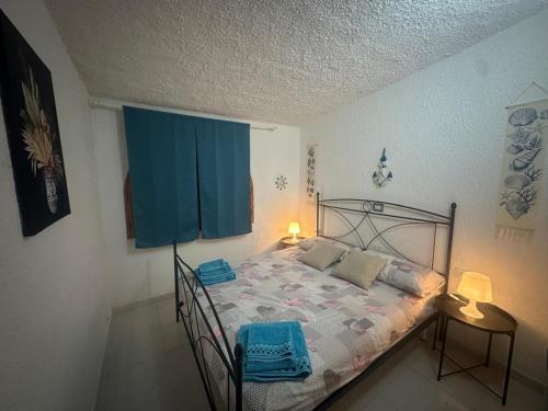 a bedroom with a bed with a blue curtain at Villetta il caminetto in Geremèas
