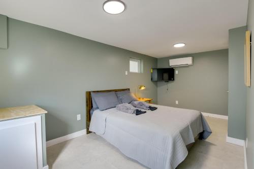 a bedroom with a bed with a white bedspread at Work and Explore in DC! Cheverly Apt half Mi to Metro in Cheverly