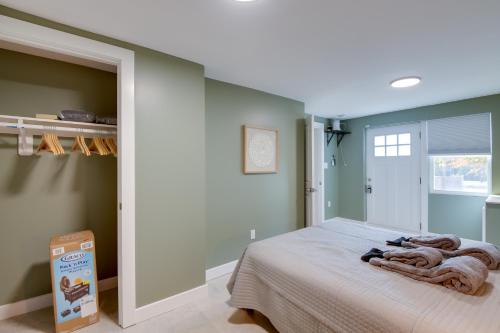 a bedroom with a bed with a blanket on it at Work and Explore in DC! Cheverly Apt half Mi to Metro in Cheverly