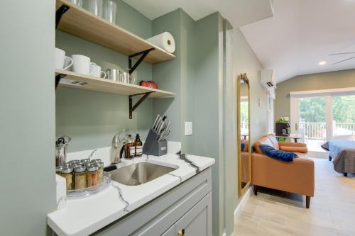 a kitchen with a sink and a living room at Walk to Metro Station! Cheverly Apt 8 Mi to DC in Cheverly
