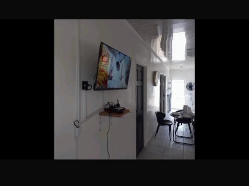 a hallway with a table and a chair in a room at Apache appartement in Paramaribo
