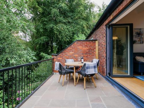 a patio with a table and chairs on a balcony at Durham City Centre Hideaway - Terrace with View & Parking in Durham