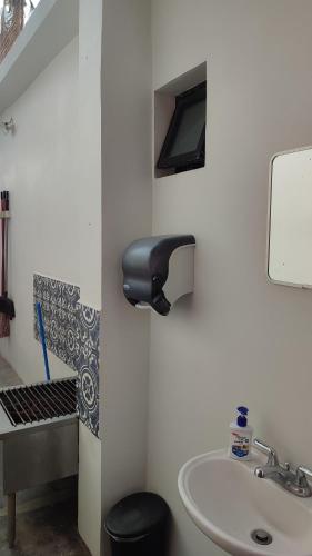 a bathroom with a sink and a faucet at Vista Delfin Beach House in San Carlos