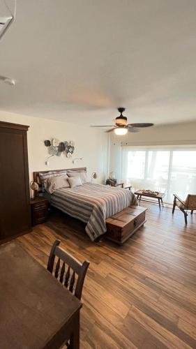 a bedroom with a bed and a ceiling fan at Vista Delfin Beach House in San Carlos