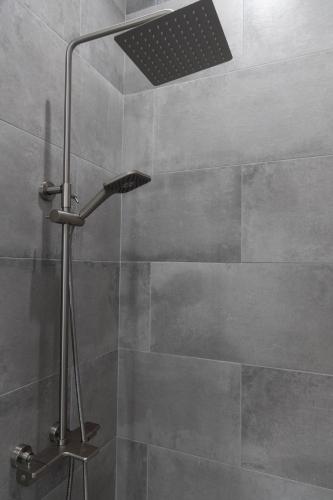 a shower with a shower head in a bathroom at An Locha B&B in Bear Tavern