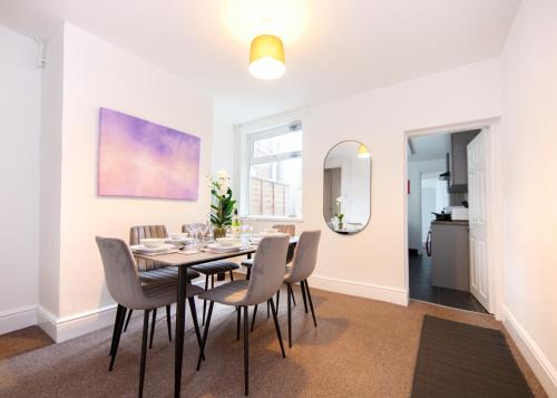 a dining room with a table and chairs at Modern 3-Bed House - Stoke on Trent in Stoke on Trent