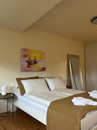 a bedroom with a bed and a painting on the wall at Stan na dan Kalin in Bugojno
