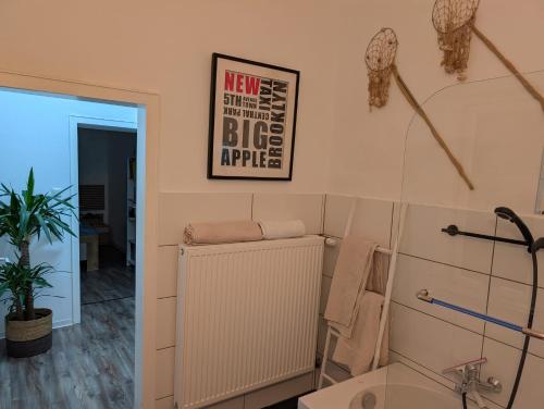 a bathroom with a tub and a sink and a mirror at Chez D&D in Eschweiler