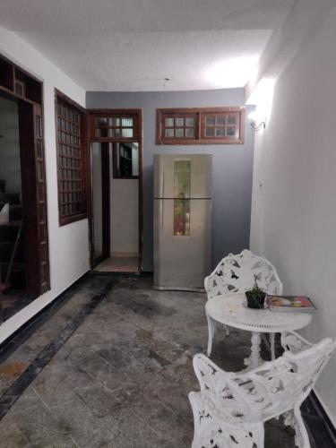 a room with a table and chairs in a room at Jomar family home in Belém