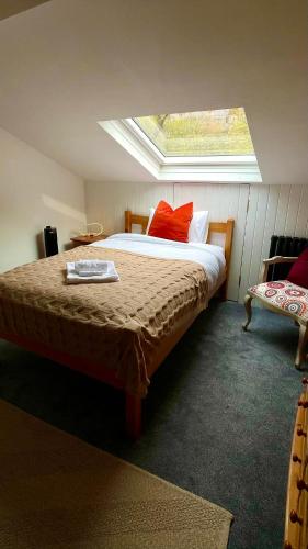 a bedroom with a large bed with a window at Durham City Centre Hideaway - Terrace with View & Parking in Durham