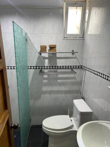 a small bathroom with a toilet and a sink at Dreamvillage in Boca Chica