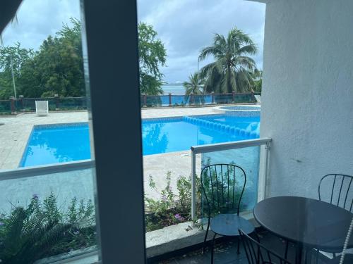 a view of a swimming pool from a balcony at Dreamvillage in Boca Chica