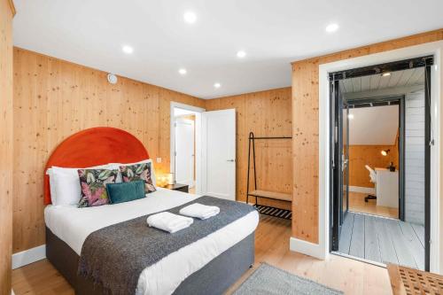 a bedroom with a large bed and a bathroom at Green Mews 1 with Free Parking By My Getaways in Brighton & Hove