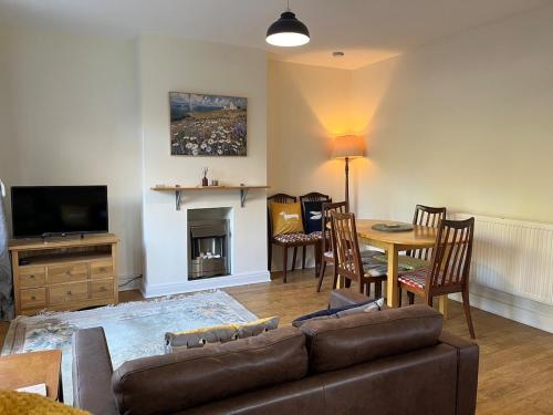 a living room with a couch and a table at Rosedale House Your home away to home in Cottingham