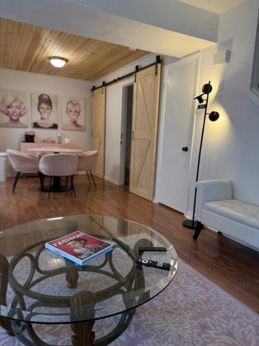 a living room with a glass table and a dining room at Chic Centrally Located 2BR Townhome at the Rez Sleeps 6 in Brandon