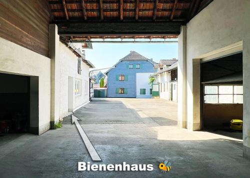 an empty alley with a blue building in the background at Bienenhaus in Troisdorf