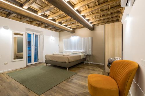 a bedroom with a bed and a chair at Boutique Atrium Pantheon in Rome