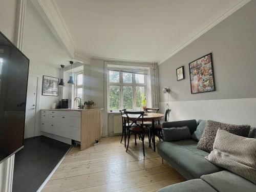 a living room with a couch and a table at Apartment in heart of Amager in Copenhagen