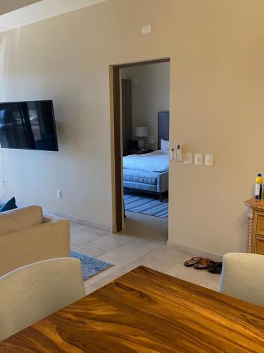 a room with a bedroom with a bed and a mirror at Copala At Quivira-Poolside Ground Floor Oceanview in Cabo San Lucas