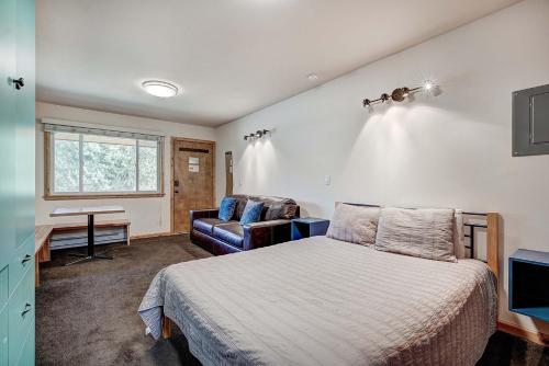 a bedroom with a bed and a chair at Park Meadows 7D by Ski Country Resorts in Breckenridge