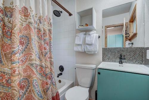 a bathroom with a toilet and a sink and a shower curtain at Park Meadows 7D by Ski Country Resorts in Breckenridge