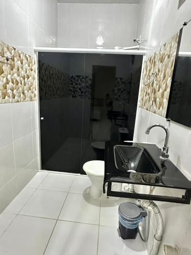 a bathroom with a sink and a toilet at Hotel Império Santarém in Santarém