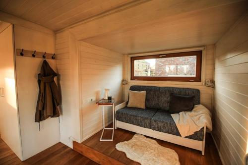 a small bedroom with a bed in a tiny house at Tiny house with view of nature in Coesfeld