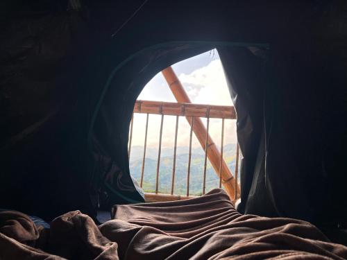a bedroom with a window with a bed and a view at Conexión naturaleza in San Luis