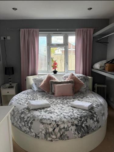a bedroom with a bed with two towels on it at The Ford, Country retreat in Arborfield