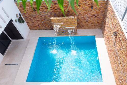 a swimming pool with a basketball hoop in a house at Casa Rincón Bonito in Puerto Escondido
