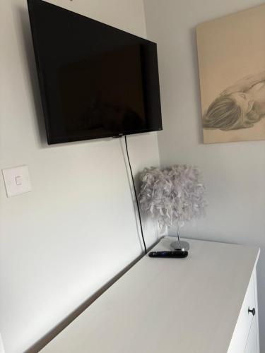 a flat screen tv on top of a white refrigerator at The Ford, Country retreat in Arborfield