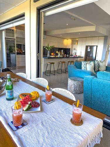 a table with two plates of food on top at Coolum Beachfront Luxury for Family and Friends in Coolum Beach