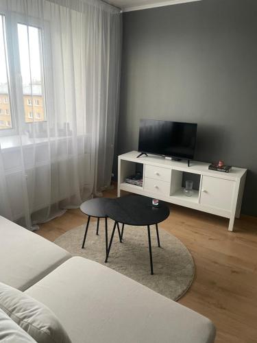a living room with a tv and a coffee table at Apartment in the city centre of Tapa in Tapa