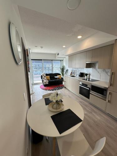 a kitchen and living room with a table in the middle at Entire Luxe Condo in Downtown Toronto in Toronto