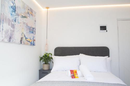 a bedroom with a bed with white pillows at Willow Brooks in Cape Town