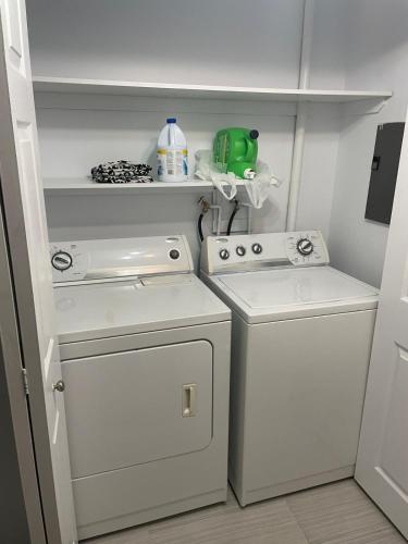 a laundry room with a washing machine and a washer at Emotions in Gatineau