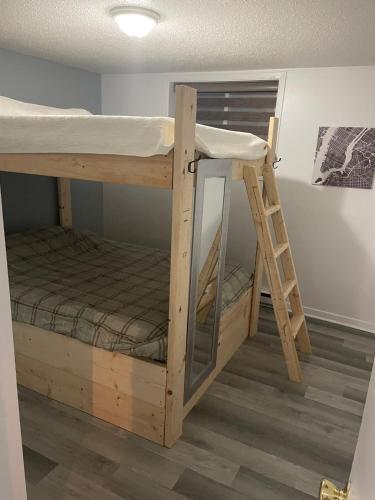 a bunk bed with a ladder in a room at Emotions in Gatineau