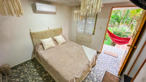 a bedroom with a bed and a large window at Habitación Bernabé in Palomino