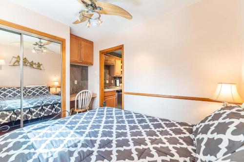 a bedroom with a blue and white bed and a mirror at Park Meadows 6A by Ski Country Resorts in Breckenridge