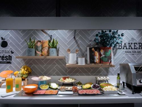 un mostrador con muchos tipos diferentes de comida en ibis Styles Santander, en Santander