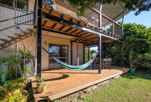 a porch with a hammock on a house at Vista at Straddie View in Dunwich