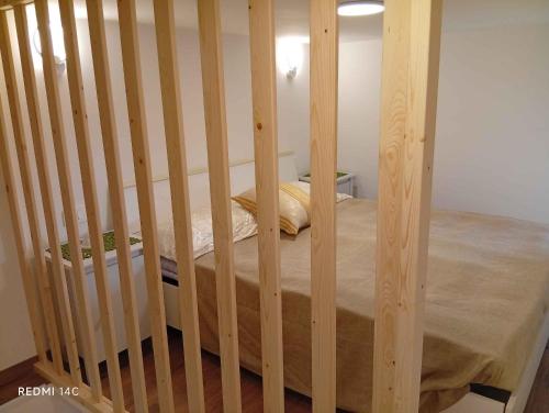 a wooden crib with a bed in a room at villa del mare in Nettuno