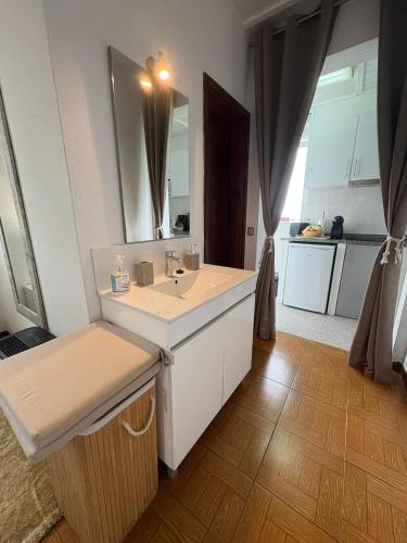 a bathroom with a sink and a mirror at Villa Alta Vista in São Jorge