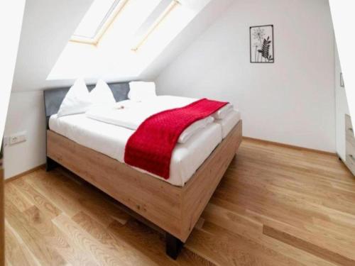 a bedroom with a bed with a red blanket on it at Bösenstein in Hohentauern