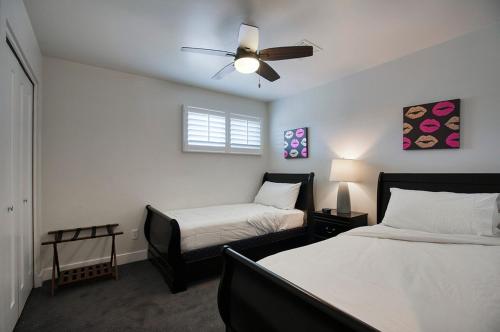 a bedroom with two beds and a ceiling fan at Dreamy Pool Home By Old Town, Sleep 14! in Scottsdale