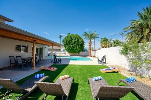 a backyard with chairs and a swimming pool and a yard with a yard at Beautiful Pool Home By Old Town, Sleep 14! in Scottsdale