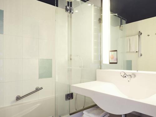 a white bathroom with a sink and a shower at Ibis styles Toulon la Seyne sur Mer in La Seyne-sur-Mer